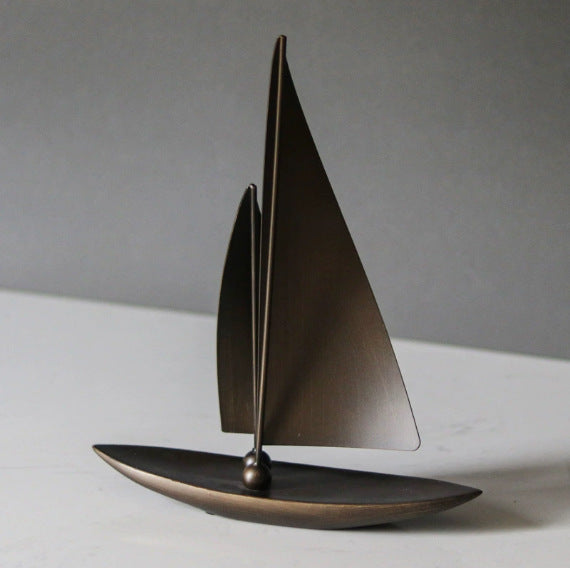 Voyage sailboat sculpture in a dark bronze-tone finish
